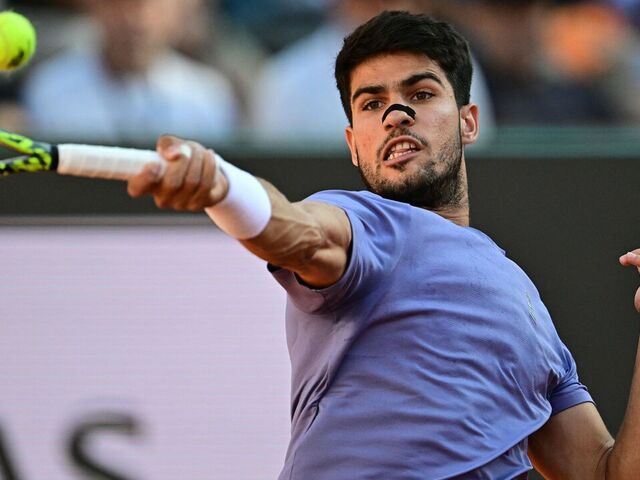 Spain's Carlos Alcaraz plays a forehand return to Italy's Jannik Sinner during their men's singles final match for the ATP Rome Open tennis tournament at Foro Italico in Rome on May 18, 2025.