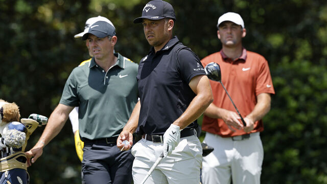 CHARLOTTE, NC - MAY 15: Xander Schauffele (USA) gets ready to play his tee shot at the 7th hole as Rory McIlroy (NIR) and Scottie Scheffler (USA) look on during the first round of the PGA Championship at Quail Hollow Country Club on May 15, 2025 in Charlotte, North Carolina.