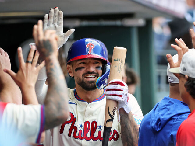 PHILADELPHIA, PENNSYLVANIA - MAY 18: Nick Castellanos #8 of the Philadelphia Phillies high-fives teammates in the dugout after scoring a run in the fifth inning during a game against the Pittsburgh Pirates at Citizens Bank Park on May 18, 2025 in Philadelphia, Pennsylvania. The Phillies won 1-0.