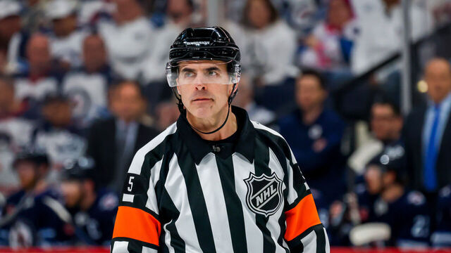 WINNIPEG, CANADA - APRIL 21: National Hockey League referee Chris Rooney #5 looks on during a second period stoppage of play between the St. Louis Blues and the Winnipeg Jets in Game Two of the First Round of the 2025 Stanley Cup Playoffs at Canada Life Centre on April 21, 2025 in Winnipeg, Manitoba, Canada.
