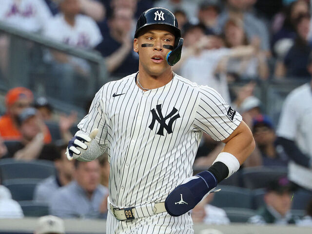 NEW YORK, NEW YORK - MAY 18: Aaron Judge #99 of the New York Yankees scores in the first inning against the New York Mets during their game at Yankee Stadium on May 18, 2025 in New York City.