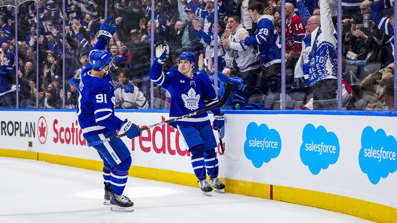 TORONTO, ON - APRIL 12: Mitch Marner #16 of the Toronto Maple Leafs celebrates his game winning goal against the Montreal Canadiens with teammate John Tavares #91 in overtime at the Scotiabank Arena on April 12, 2025 in Toronto, Ontario, Canada.