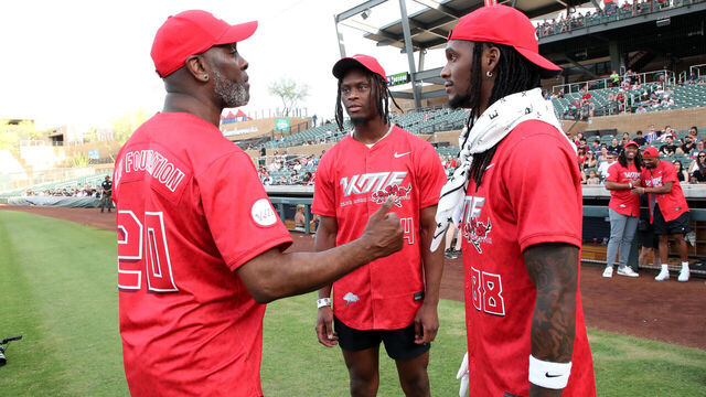 SCOTTSDALE, ARIZONA - MAY 17: Former NBA superstar Gary Payton chats with Dallas Cowboys wide receivers George Pickens and Ceedee Lamb during the first annual Kyler Murray Foundation softball game at Salt River Fields at Talking Stick on May 17, 2025 in Scottsdale, Arizona.