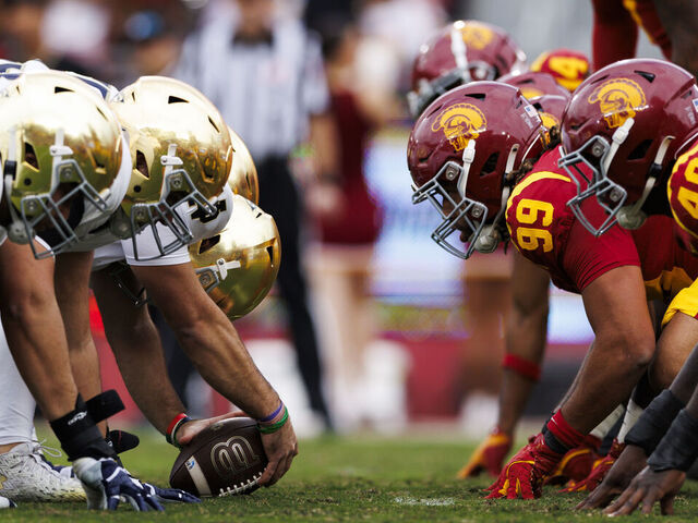 LOS ANGELES, CALIFORNIA - NOVEMBER 30: Notre Dame Fighting Irish offense and USC Trojans defense at the line of scrimmage before an extra point attempt during the first half at United Airlines Field at the Los Angeles Memorial Coliseum on November 30, 2024 in Los Angeles, California.