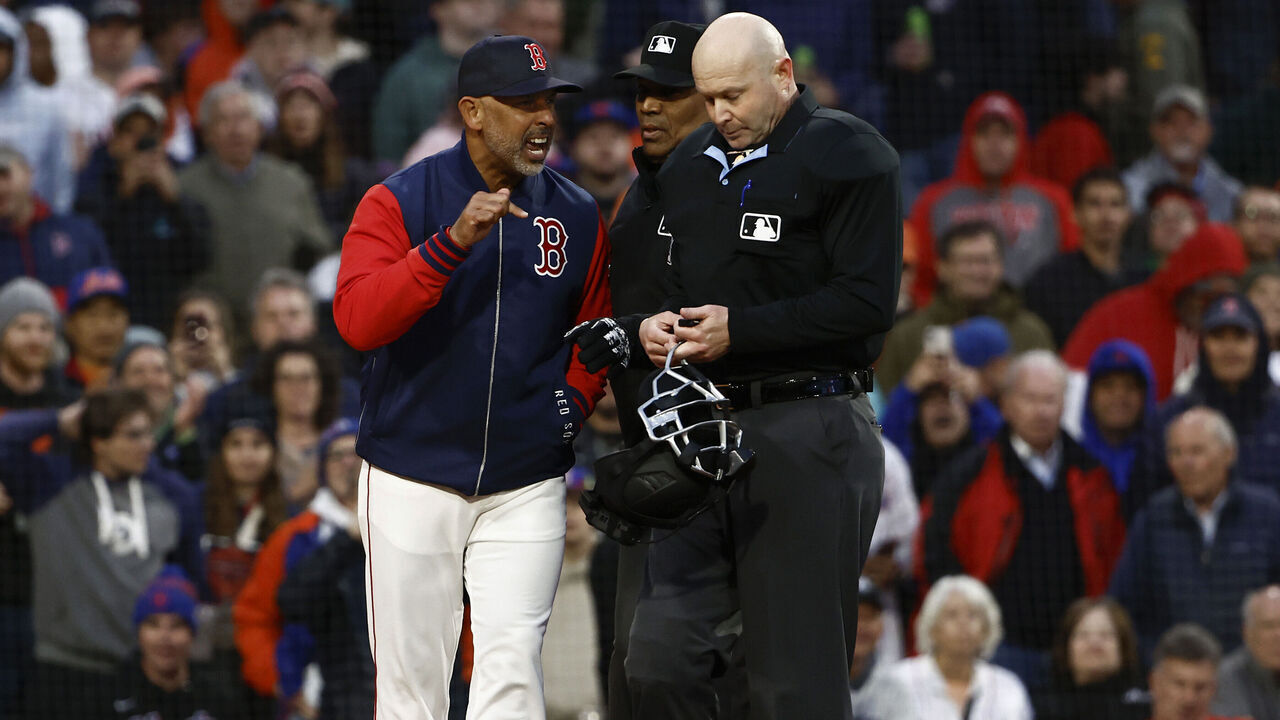 BOSTON, MA - MAY 20: Manager Alex Cora #13 of the Boston Red Sox argues with home plate umpire Mike Estabrook #83 after he and pitcher Walker Buehler #0 were thrown out of the game for arguing balls and strikes during the second inning against the New York Mets at Fenway Park on May 20, 2025 in Boston, Massachusetts.