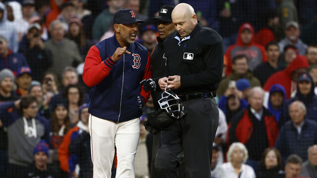 BOSTON, MA - MAY 20: Manager Alex Cora #13 of the Boston Red Sox argues with home plate umpire Mike Estabrook #83 after he and pitcher Walker Buehler #0 were thrown out of the game for arguing balls and strikes during the second inning against the New York Mets at Fenway Park on May 20, 2025 in Boston, Massachusetts.