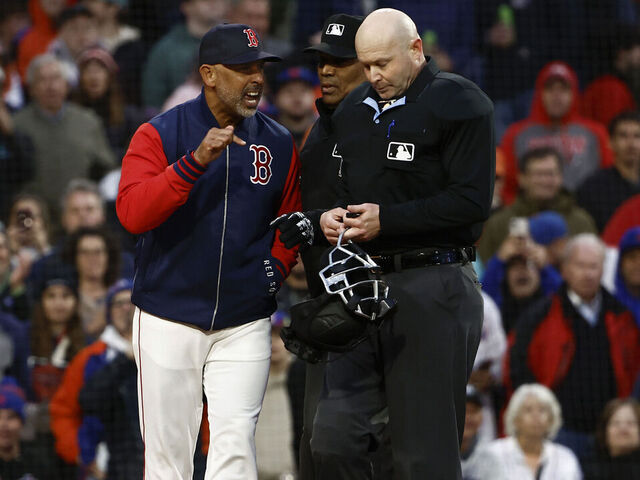 BOSTON, MA - MAY 20: Manager Alex Cora #13 of the Boston Red Sox argues with home plate umpire Mike Estabrook #83 after he and pitcher Walker Buehler #0 were thrown out of the game for arguing balls and strikes during the second inning against the New York Mets at Fenway Park on May 20, 2025 in Boston, Massachusetts.