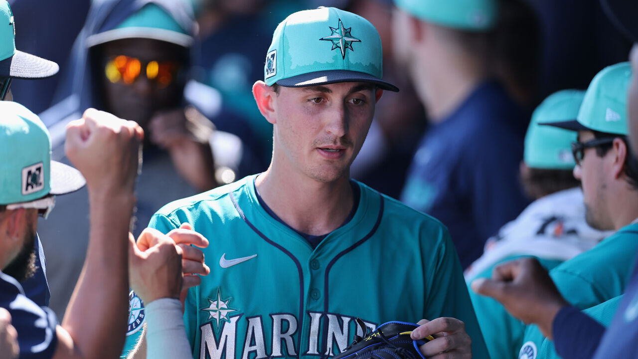 PEORIA, ARIZONA - FEBRUARY 26: Starting pitcher George Kirby #68 of the Seattle Mariners high fives teammates in the dugout after pitching against the Athletics during the second inning of the MLB game at Peoria Stadium on February 26, 2025 in Peoria, Arizona.