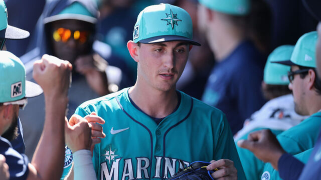 PEORIA, ARIZONA - FEBRUARY 26: Starting pitcher George Kirby #68 of the Seattle Mariners high fives teammates in the dugout after pitching against the Athletics during the second inning of the MLB game at Peoria Stadium on February 26, 2025 in Peoria, Arizona.
