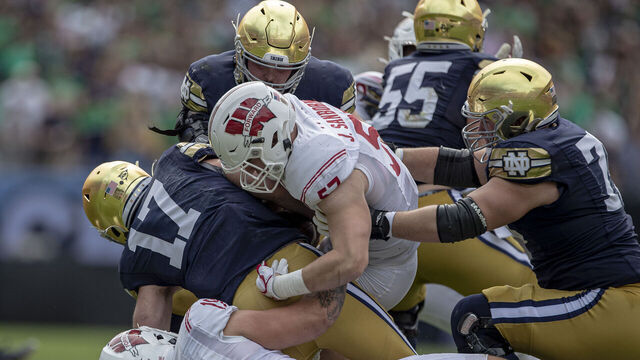 CHICAGO, IL - SEPTEMBER 25: Wisconsin Badgers outside linebacker Nick Herbig (19) and Wisconsin Badgers inside linebacker Jack Sanborn (57) sack Notre Dame Fighting Irish quarterback Jack Coan (17) and injures his ankle in the process durning a college football game between the Notre Dame Fighting Irish and the Wisconsin Badgers on September 25th, 2021 at Solider Field in Chicago, IL.