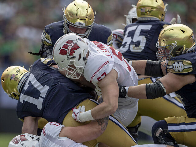 CHICAGO, IL - SEPTEMBER 25: Wisconsin Badgers outside linebacker Nick Herbig (19) and Wisconsin Badgers inside linebacker Jack Sanborn (57) sack Notre Dame Fighting Irish quarterback Jack Coan (17) and injures his ankle in the process durning a college football game between the Notre Dame Fighting Irish and the Wisconsin Badgers on September 25th, 2021 at Solider Field in Chicago, IL.