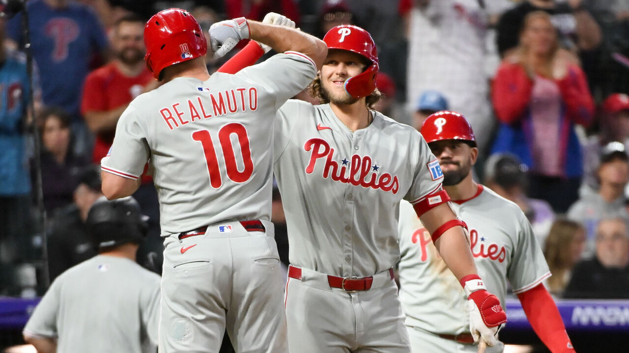 DENVER, CO - MAY 21: J.T. Realmuto #10 of the Philadelphia Phillies celebrates with Alec Bohm #28 after hitting a two-run home run in the sixth inning during the game between the Philadelphia Phillies and the Colorado Rockies at Coors Field on Wednesday, May 21, 2025 in Denver, Colorado.