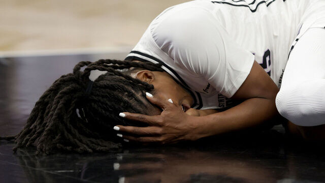 SAN FRANCISCO, CALIFORNIA - MAY 21: Tiffany Hayes #15 of the Golden State Valkyries holds her head after colliding with Shakira Austin #0 of the Washington Mystics during the first half at Chase Center on May 21, 2025 in San Francisco, California.