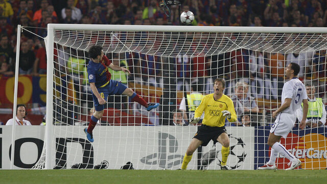 Lionel Messi of Barcelona beats goalkeeper Edwin van der Sar of Manchester United with a header to score the second goal during the UEFA Champions League Final between Barcelona and Manchester United at the Stadio Olimpico in Rome, Italy.