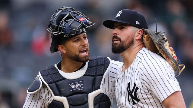 NEW YORK, NEW YORK - MAY 22: J.C. Escarra #25 and Carlos Rodon #55 of the New York Yankees walk off the field during the sixth inning of the game against the Texas Rangers at Yankee Stadium on May 22, 2025 in New York City.