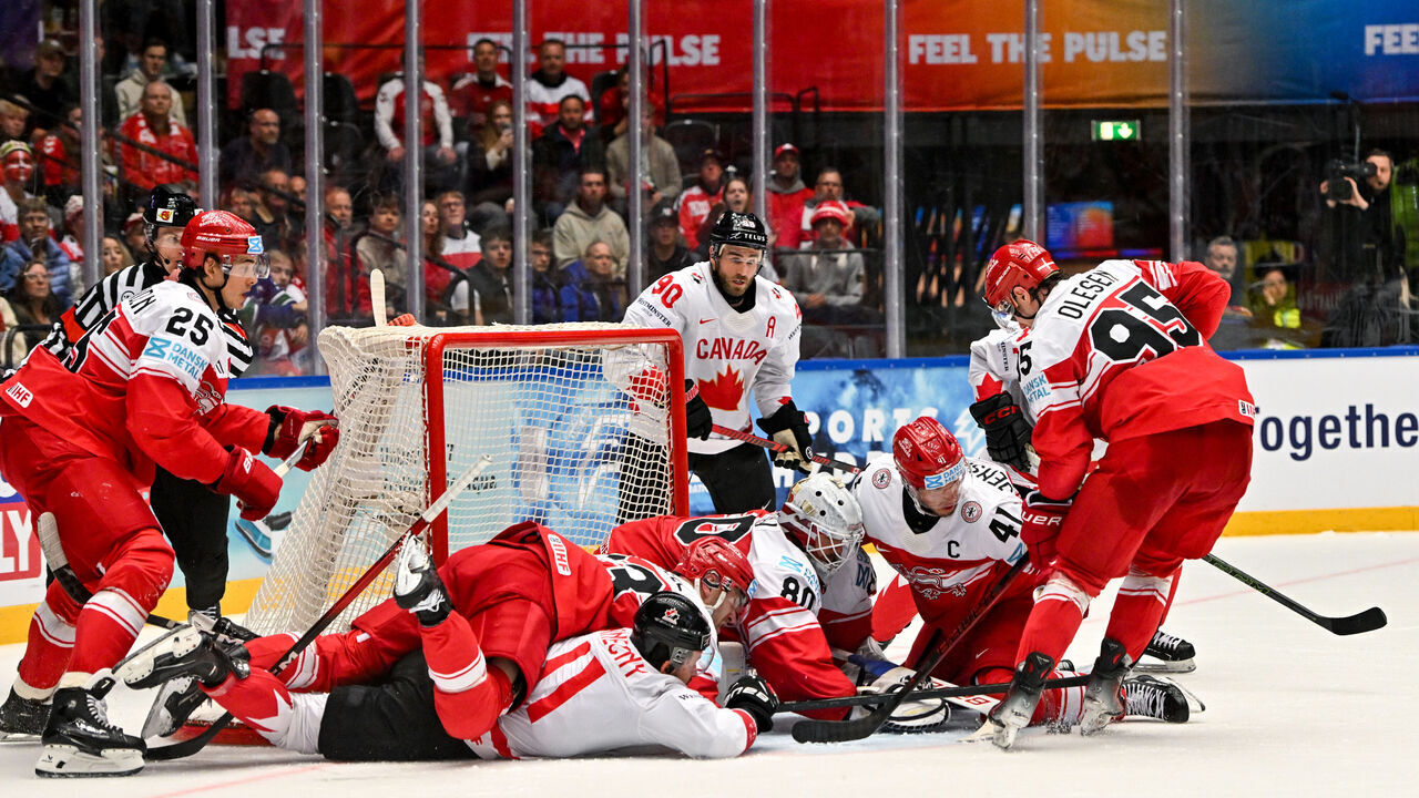 ODENSE, DENMARK - MAY 22: A battle for the puck in front of goalkeeper Frederik Dichow of Denmark during the 2025 Ice Hockey World Championship match between Canada and Denmark at Jyske Bank Arena on May 22, 2025 in Odense, Denmark.