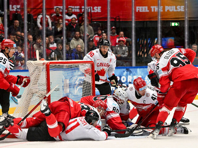 ODENSE, DENMARK - MAY 22: A battle for the puck in front of goalkeeper Frederik Dichow of Denmark during the 2025 Ice Hockey World Championship match between Canada and Denmark at Jyske Bank Arena on May 22, 2025 in Odense, Denmark.