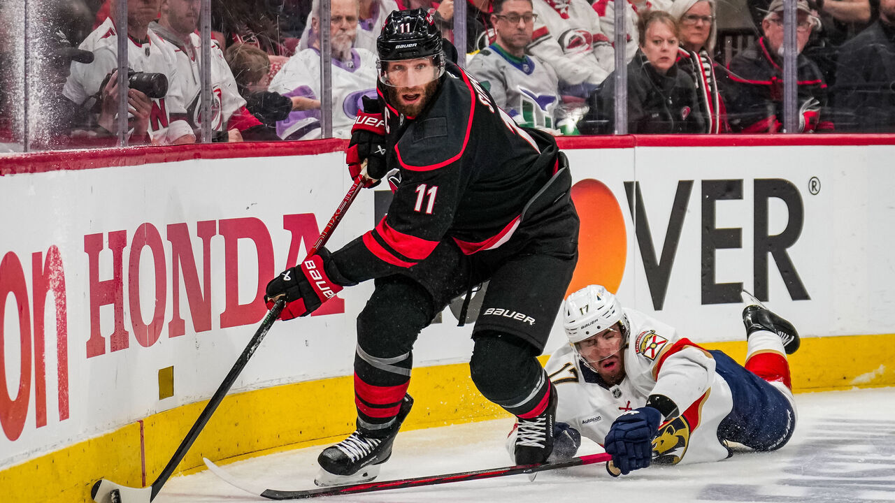 RALEIGH, NC - MAY 22: Jordan Staal #11 of the Carolina Hurricanes skates with the puck as Evan Rodrigues #17 of the Florida Panthers falls to the ice during the first period of Game Two of the Eastern Conference Final of the 2025 Stanley Cup Playoffs at Lenovo Center on May 22, 2025 in Raleigh, North Carolina.