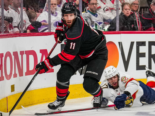 RALEIGH, NC - MAY 22: Jordan Staal #11 of the Carolina Hurricanes skates with the puck as Evan Rodrigues #17 of the Florida Panthers falls to the ice during the first period of Game Two of the Eastern Conference Final of the 2025 Stanley Cup Playoffs at Lenovo Center on May 22, 2025 in Raleigh, North Carolina.