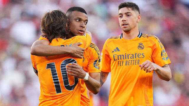 SEVILLE, SPAIN - MAY 18: Kylian Mbappe of Real Madrid celebrates scoring his team's first goal with teammates Luka Modric and Federico Valverde during the LaLiga match between Sevilla FC and Real Madrid CF at Estadio Ramon Sanchez Pizjuan on May 18, 2025 in Seville, Spain.