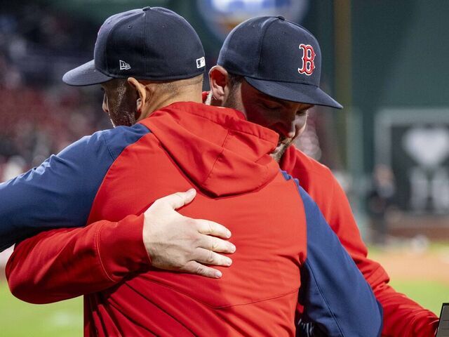 BOSTON, MA - SEPTEMBER 20: Liam Hendriks #31 of the Boston Red Sox is recognized as the Boston Red Sox Nominee for the 2024 Roberto Clemente Award and greeted by manager Alex Cora, Scott Dulin of the Roberto Clemente Foundation and his wife during a pre-game ceremony before a game against the Minnesota Twins on September 20, 2024 at Fenway Park in Boston, Massachusetts.
