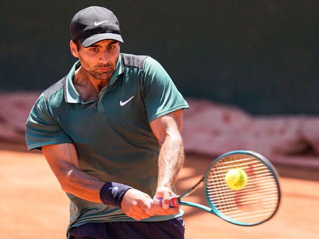 PARIS, FRANCE - MAY 23: Benjamin Hassan of Lebanon plays a backhand in the Men's Singles Qualifying Round match against James Kent Trotter of Japan during the Day 5 of the opening week at Roland Garros on May 23, 2025 in Paris, France.