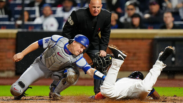 NEW YORK, NY - MAY 23: Starling Marte #6 of the New York Mets dives into home safely in the fourth inning while Will Smith #16 of the Los Angeles Dodgers applies the tag during the game between the Los Angeles Dodgers and the New York Mets at Citi Field on Friday, May 23, 2025 in New York, New York.