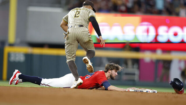 ATLANTA, GEORGIA - MAY 23: Eli White #36 of the Atlanta Braves is tagged out at second by Xander Bogaerts #2 of the San Diego Padres during the ninth inning at Truist Park on May 23, 2025 in Atlanta, Georgia.