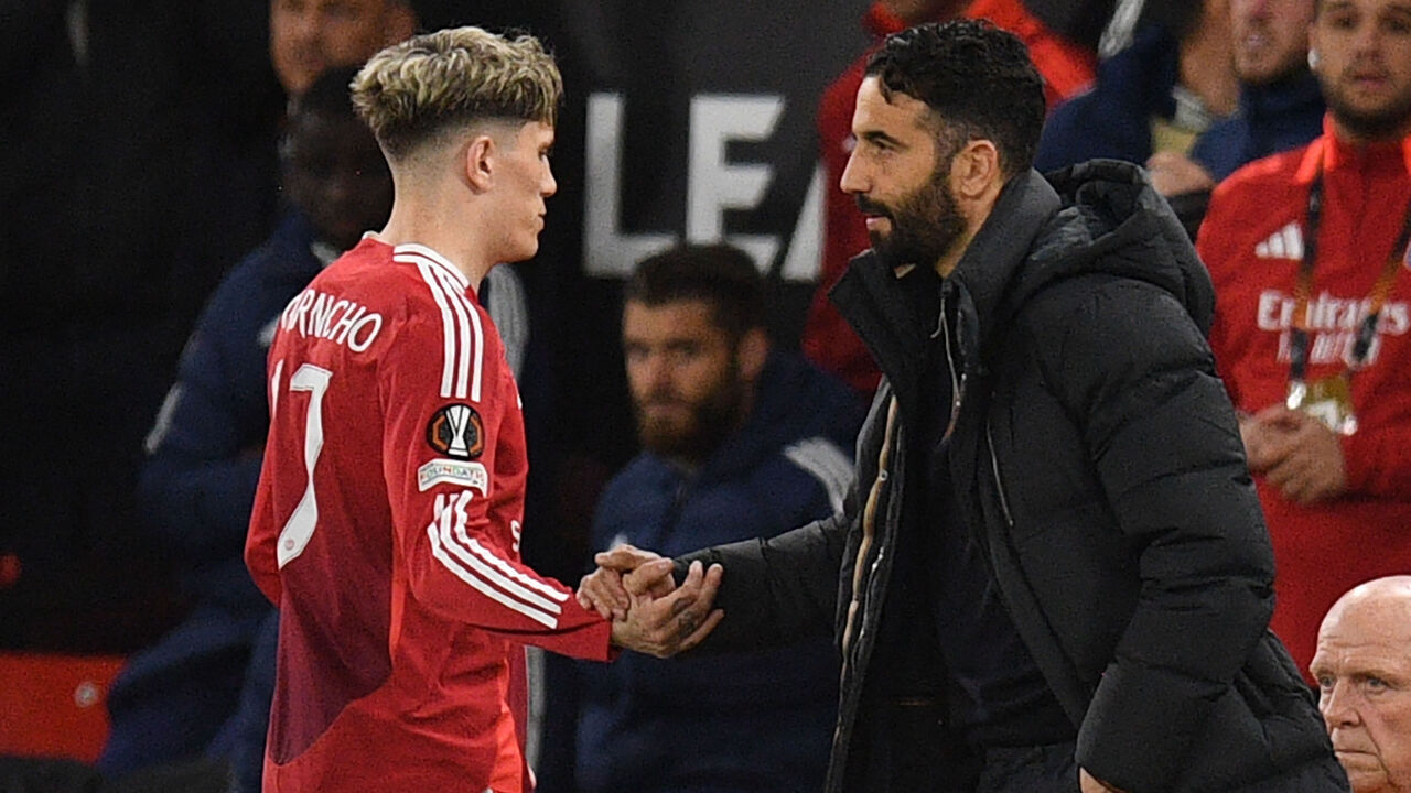 Manchester United's Portuguese head coach Ruben Amorim (R) shakes hands with Manchester United's Argentinian midfielder #17 Alejandro Garnacho (L) as he leaves the game, substituted during the UEFA Europa league quarter-final final, second leg football match between Manchester United and Lyon at Old Trafford stadium in Manchester, north west England, on April 17, 2025.