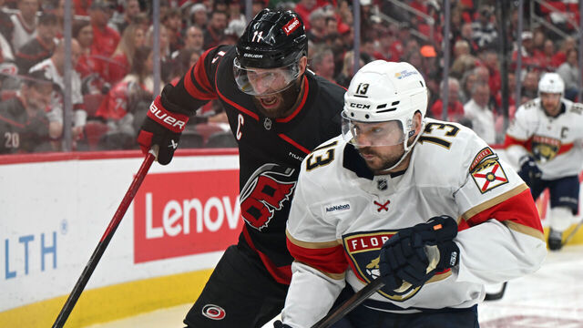 RALEIGH, NC - MAY 20: Carolina Hurricanes center Jordan Staal (11) and Florida Panthers center Sam Reinhart (13) battle for the puck along the boards during game one of the Eastern Conference Final of the NHL Stanley Cup Playoffs between the Florida Panthers and the Carolina Hurricanes on May 20, 2025 at Lenovo Center in Raleigh, North Carolina.