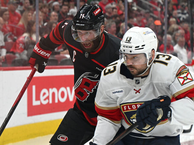 RALEIGH, NC - MAY 20: Carolina Hurricanes center Jordan Staal (11) and Florida Panthers center Sam Reinhart (13) battle for the puck along the boards during game one of the Eastern Conference Final of the NHL Stanley Cup Playoffs between the Florida Panthers and the Carolina Hurricanes on May 20, 2025 at Lenovo Center in Raleigh, North Carolina.
