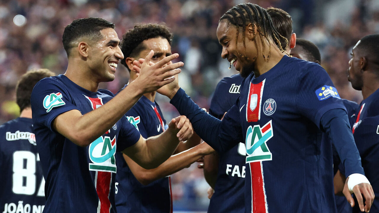 Paris Saint-Germain's Moroccan defender #02 Achraf Hakimi (L) celebrates with Paris Saint-Germain's French forward #29 Bradley Barcola (R) after scoring his team's third goal during the French Cup final football match between Paris Saint-Germain (PSG) and Stade de Reims at the Stade de France in Saint-Denis, north of Paris, on May 24, 2025.
