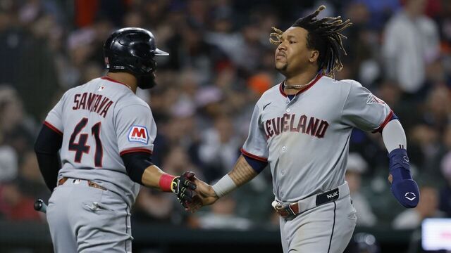 DETROIT, MI - MAY 24: José Ramírez #11 of the Cleveland Guardians celebrates with Carlos Santana #41 after scoring to take a 4-3 lead over the Detroit Tigers during the 10th inning at Comerica Park on May 24, 2025 in Detroit, Michigan.