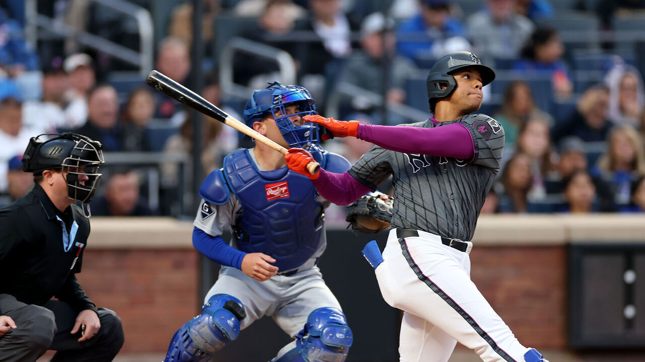 NEW YORK, NEW YORK - MAY 24: Juan Soto #22 of the New York Mets flies out to center as Dalton Rushing #68 of the Los Angeles Dodgers defends in the first inning at Citi Field on May 24, 2025 in the Flushing neighborhood of the Queens borough of New York City.
