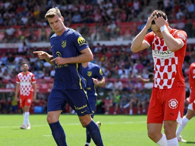 Atletico Madrid's Norwegian forward #09 Alexander Sorloth (R) celebrates scoring his team's first goal during the Spanish league football match between Girona FC and Club Athletic de Madrid at Montilivi Stadium in Girona, on May 25, 2025.