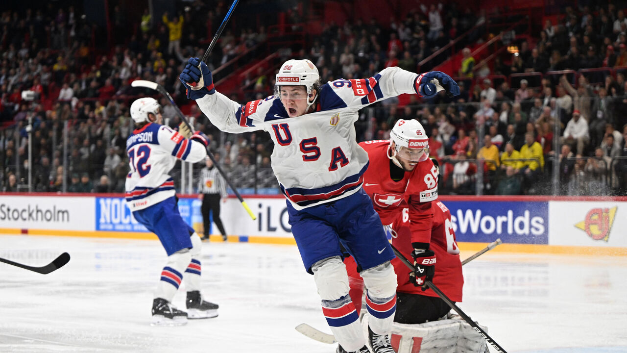 US forward #92 Logan Cooley (C) celebrates after his team mates US forward #72 Tage Thompson (L) scored the goal to win gold during the overtime of the IIHF Men's Ice Hockey World Championship final match between Switzerland and USA in Stockholm, on May 25, 2025.