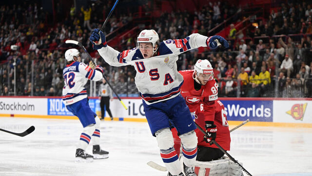 US forward #92 Logan Cooley (C) celebrates after his team mates US forward #72 Tage Thompson (L) scored the goal to win gold during the overtime of the IIHF Men's Ice Hockey World Championship final match between Switzerland and USA in Stockholm, on May 25, 2025.