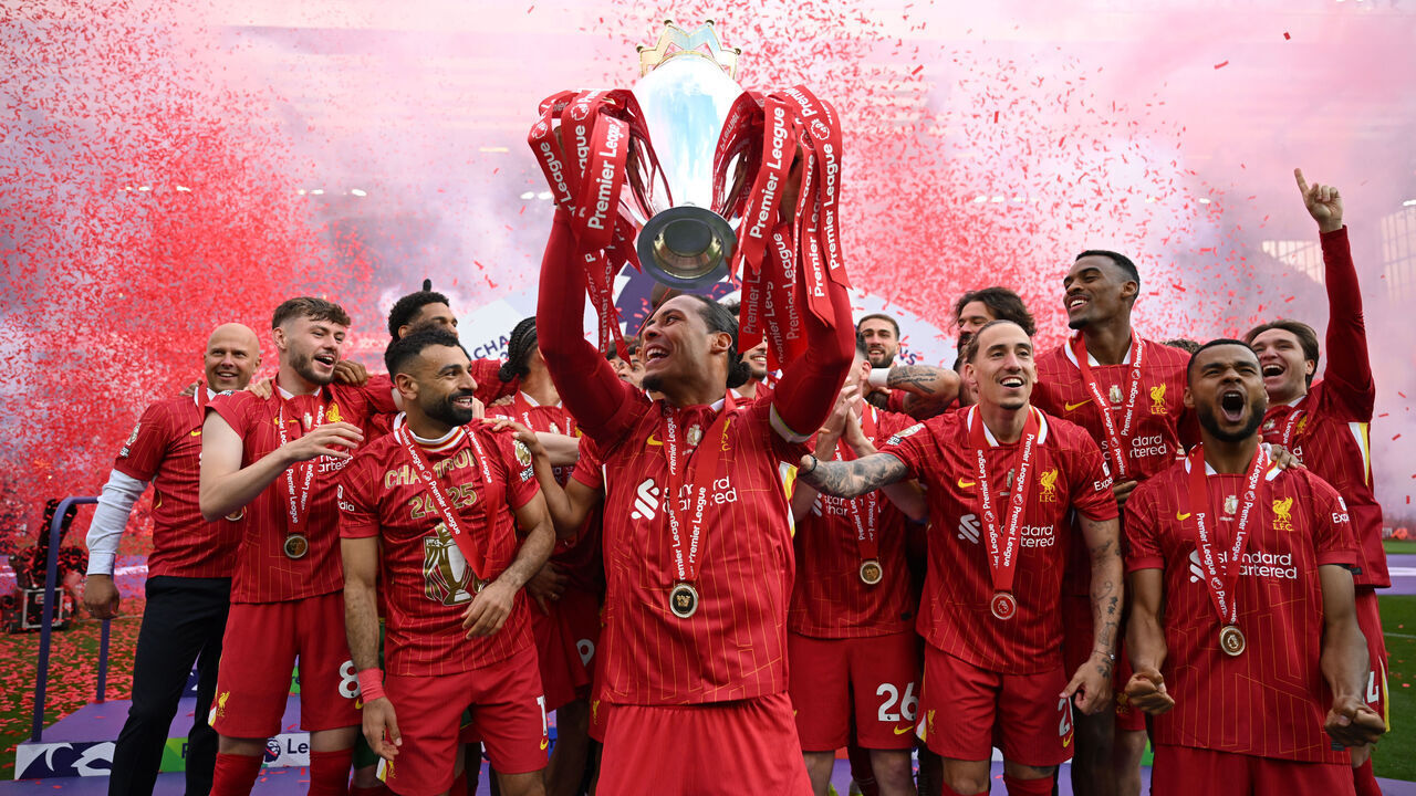 LIVERPOOL, ENGLAND - MAY 25: Virgil van Dijk of Liverpool, lifts the Premier League trophy, as Liverpool are crowned the Champions of the Premier League for the 2024/25 Season, following the Premier League match between Liverpool FC and Crystal Palace FC at Anfield on May 25, 2025 in Liverpool, England.