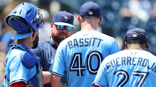 TAMPA, FL - MAY 25: Manager John Schneider #14 of the Toronto Blue Jays talks with Chris Bassitt #40 in the fifth inning during the game between the Toronto Blue Jays and the Tampa Bay Rays at George M. Steinbrenner Field on Sunday, May 25, 2025 in Tampa, Florida.