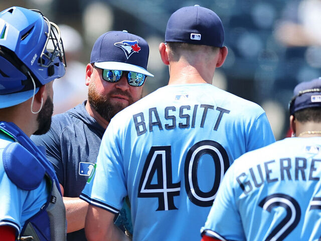 TAMPA, FL - MAY 25: Manager John Schneider #14 of the Toronto Blue Jays talks with Chris Bassitt #40 in the fifth inning during the game between the Toronto Blue Jays and the Tampa Bay Rays at George M. Steinbrenner Field on Sunday, May 25, 2025 in Tampa, Florida.