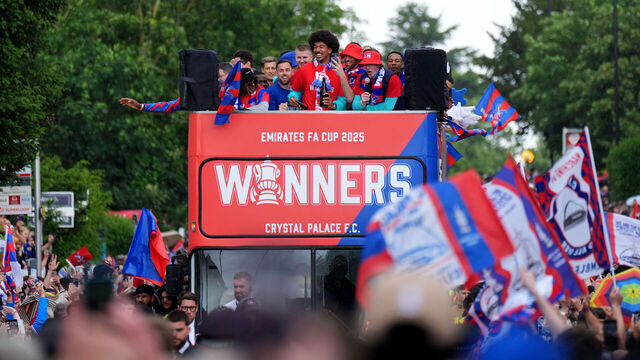 Crystal Palace players on a open-top bus pass by fans during the FA Cup winners parade in London. Crystal Palace won the FA Cup after a 1-0 victory over Manchester City at Wembley. Picture date: Monday May 26, 2025.
