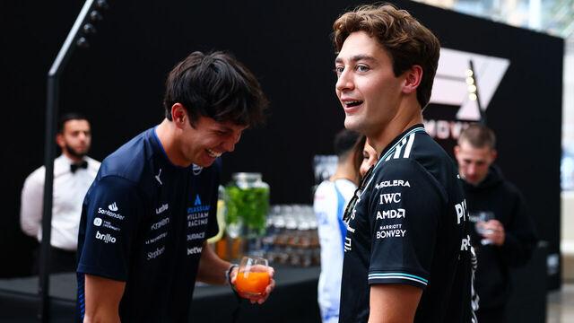 MONACO, MONACO - MAY 21: George Russell of Great Britain and Mercedes AMG Petronas F1 Team, shares a joke with Alexander Albon of Thailand and Williams, while attending the private screening of F1® The Movie prior to the F1 Grand Prix of Monaco at Grimaldi Forum on May 21, 2025 in Monaco, Monaco.