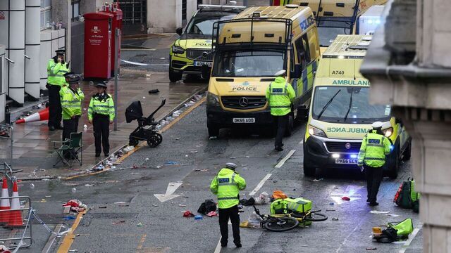 Police officers investigate the scene of an incident in Water Street, on the sidelines of an open-top bus victory parade for Liverpool's Premier League title win, in Liverpool, north-west England on May 26, 2025.
