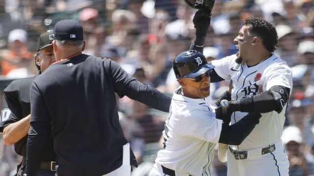 DETROIT, MI - MAY 26: Javier Baez #28 (R) of the Detroit Tigers is held back by third base coach Joey Cora #56 after being called out on strikes as manager manager A.J. Hinch #14 argues with home plate umpire Phil Cuzzi in the fifth inning at Comerica Park on May 26, 2025 in Detroit, Michigan.