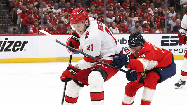 SUNRISE, FLORIDA - MAY 26: Alexander Nikishin #21 of the Carolina Hurricanes skates with the puck against Jesper Boqvist #70 of the Florida Panthers during the third period in Game Four of the Eastern Conference Final of the 2025 Stanley Cup Playoffs at Amerant Bank Arena on May 26, 2025 in Sunrise, Florida.