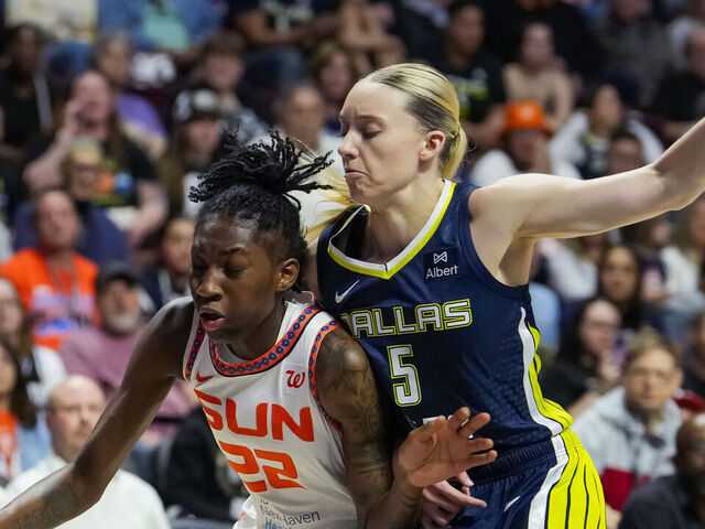UNCASVILLE, CONNECTICUT - MAY 27: Saniya Rivers #22 of the Connecticut Sun posts up against Paige Bueckers #5 of the Dallas Wings during the first half at Mohegan Sun Arena on May 27, 2025 in Uncasville, Connecticut.
