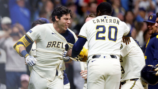 MILWAUKEE, WISCONSIN - MAY 27: Christian Yelich #22 of the Milwaukee Brewers is congratulated by teammates after hitting a walk-off grand slam in the 10th inning against the Boston Red Sox at American Family Field on May 27, 2025 in Milwaukee, Wisconsin.