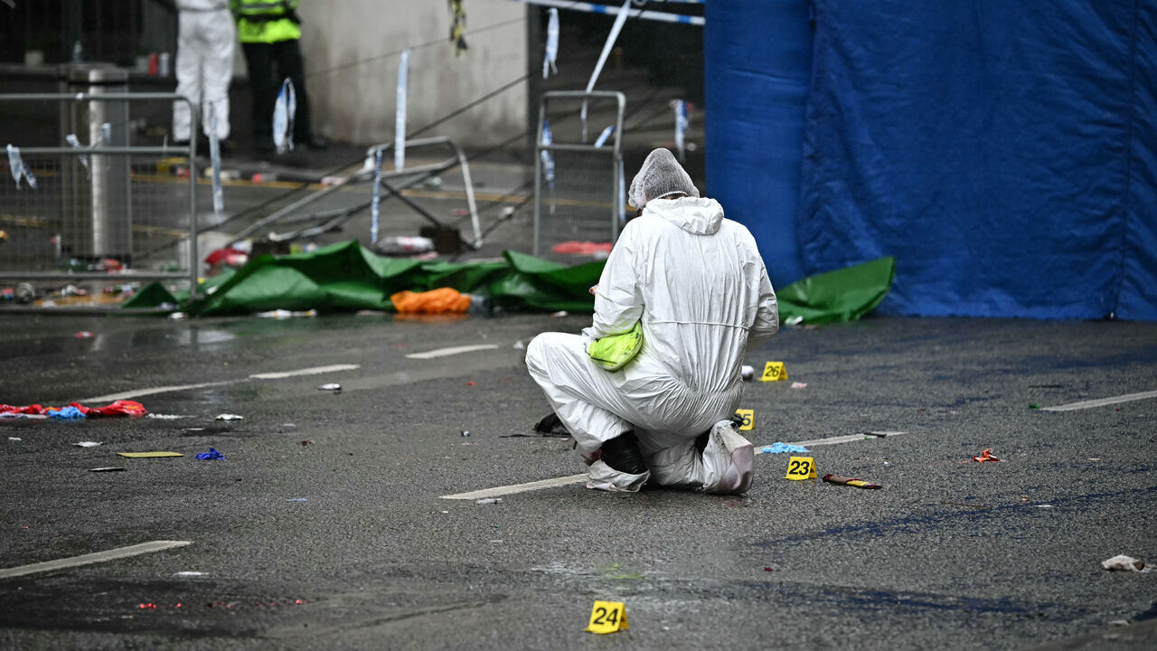 A police forensic officer works at the scene on Water Street in Liverpool, north-west England on May 27, 2025, where a car ploughed in to crowds that had gathered on May 26 to watch an open-top bus victory parade for Liverpool's Premier League trophy parade. Police said Monday they were not treating a Liverpool car ramming which left 27 people hospitalised as terrorism, after a vehicle ploughed into crowds celebrating Liverpool's Premier League football title. "We believe this to be an isolated incident, and we are not currently looking for anyone else in relation to it," Merseyside Police Assistant Chief Constable Jenny Sims told a press conference, adding a 53-year-old British man had been arrested.