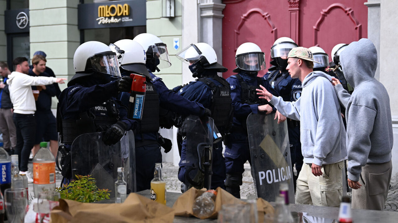 Polish riot police officers stand between groups of Real Betis and Chelsea fans to prevent clash ahead the UEFA Conference League Final between Real Betis and Chelsea FC in Wroclaw on May 28, 2025.