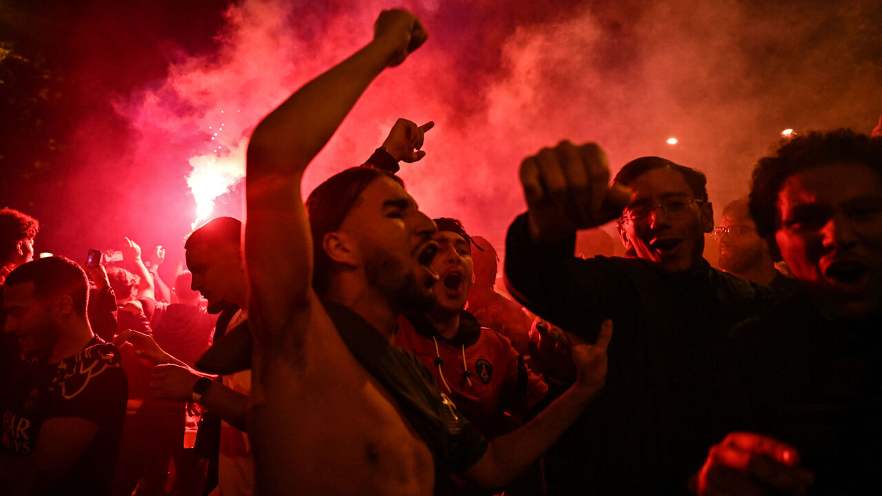 Paris Saint-Germain supporters celebrate after PSG won the UEFA Champions League final football match between Paris Saint-Germain (PSG) and Inter Milan held in Munich, on the Champs-Elysees avenue in Paris on May 31, 2025.